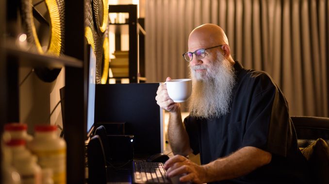 bald bearded man drinking coffee
